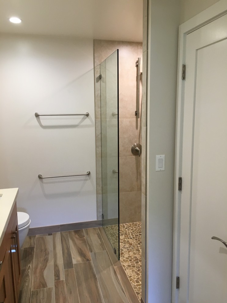 Example of a mid-sized beach style master beige tile and porcelain tile porcelain tile and brown floor bathroom design in Hawaii with shaker cabinets, dark wood cabinets, a wall-mount toilet, white walls, an undermount sink and quartzite countertops
