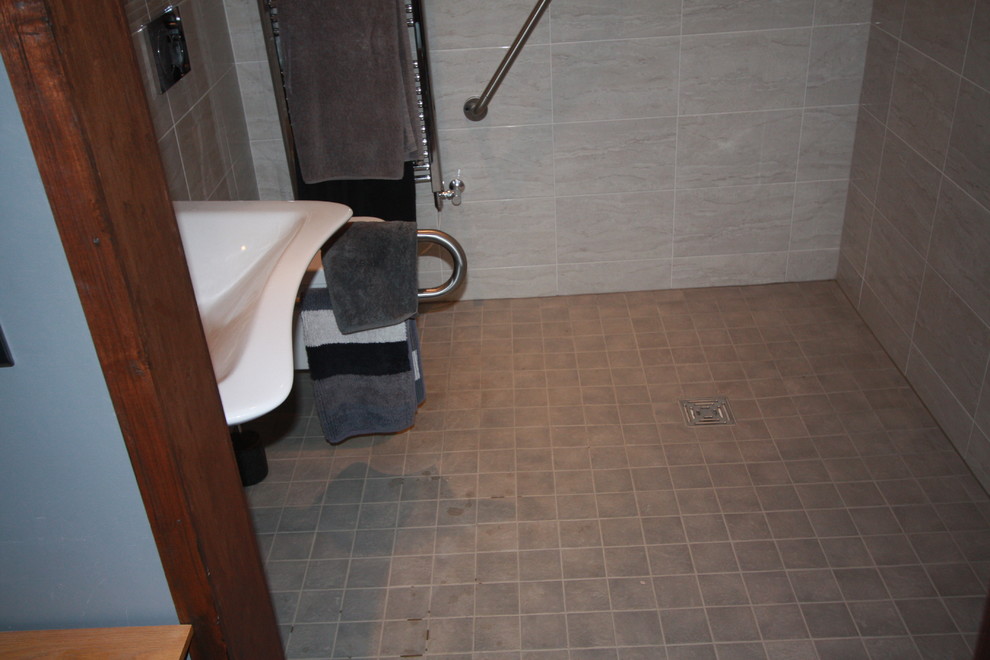 Foto di una stanza da bagno padronale minimalista con lavabo sospeso, doccia aperta, WC sospeso, piastrelle grigie, piastrelle in ceramica, pareti grigie e pavimento in gres porcellanato