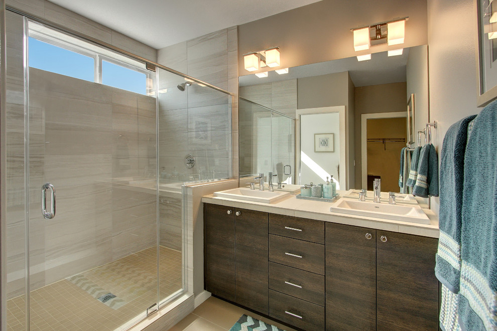 Inspiration for a modern ensuite bathroom in Seattle with a built-in sink, flat-panel cabinets, brown cabinets, a two-piece toilet, brown tiles and brown walls.