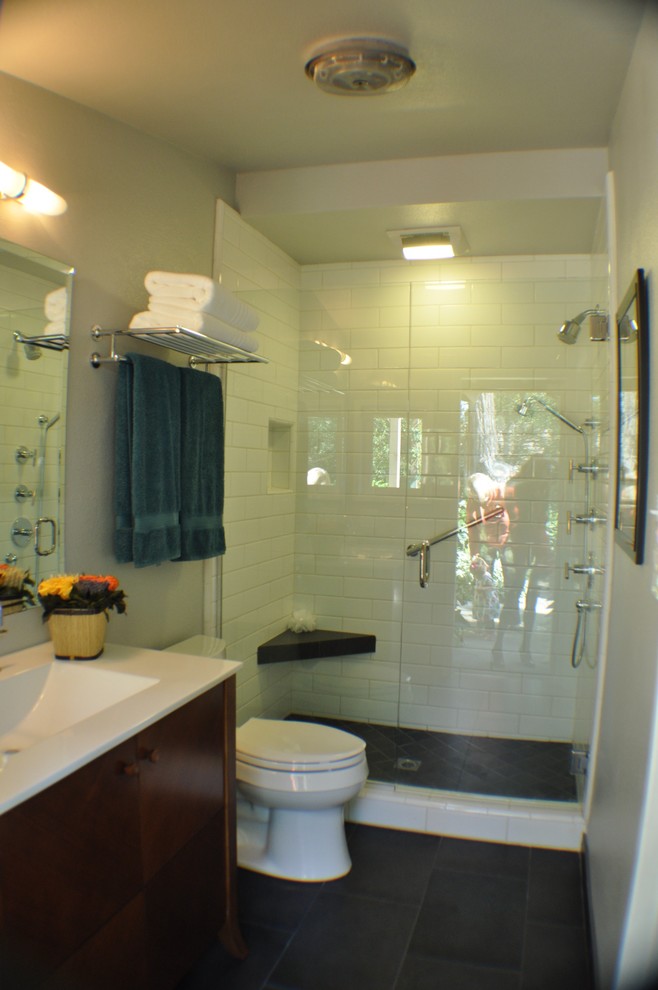 Alcove shower - mid-sized traditional 3/4 white tile and subway tile porcelain tile alcove shower idea in Orange County with flat-panel cabinets, medium tone wood cabinets, a two-piece toilet, white walls and quartz countertops