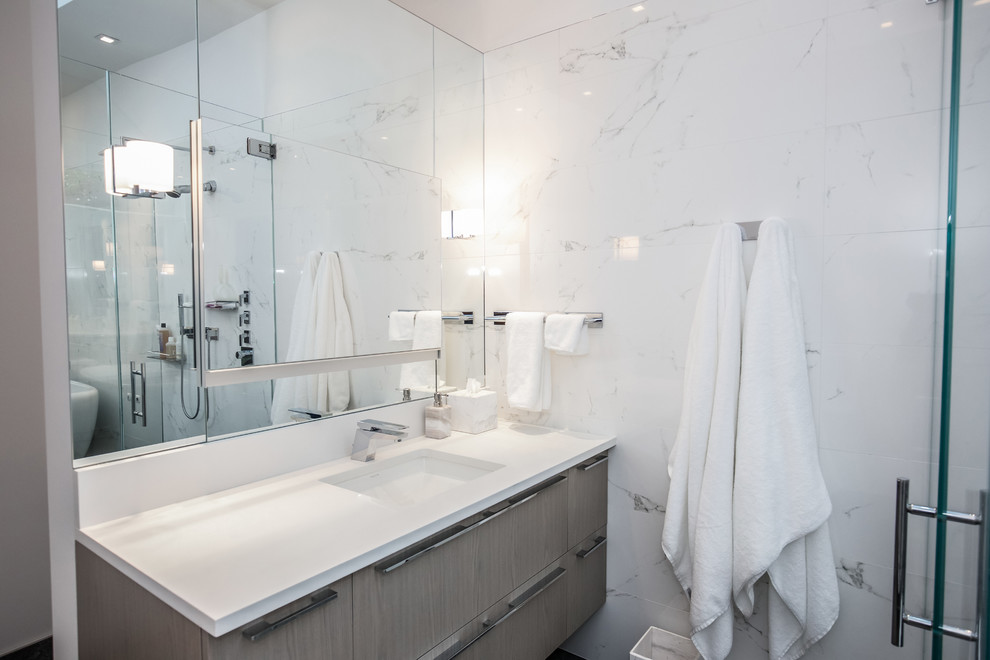 This is an example of a large contemporary ensuite bathroom in DC Metro with a freestanding bath, a walk-in shower, a one-piece toilet, white walls, a built-in sink, black floors and an open shower.