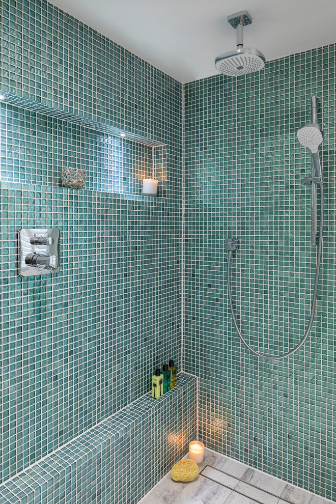 Coastal wet room bathroom in London with blue tiles, green tiles, mosaic tiles, green walls and grey floors.