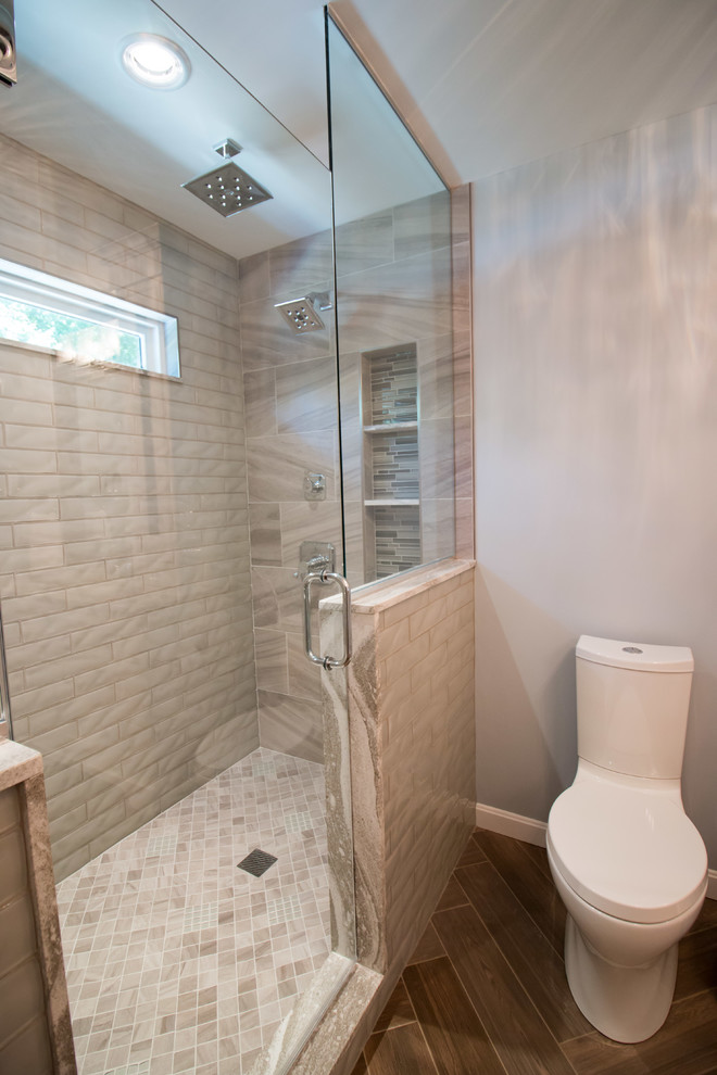 Inspiration for a medium sized modern ensuite bathroom in Boston with beaded cabinets, white cabinets, an alcove shower, a two-piece toilet, multi-coloured tiles, porcelain tiles, blue walls, porcelain flooring, a submerged sink, engineered stone worktops, brown floors, brown worktops and a hinged door.
