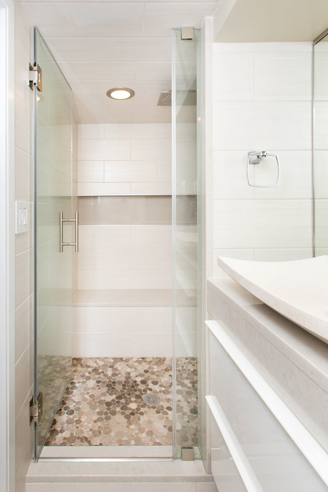 Alcove shower - mid-sized contemporary 3/4 pebble tile alcove shower idea in DC Metro with flat-panel cabinets, white cabinets, beige walls and a vessel sink