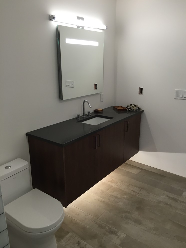 1960s ceramic tile bathroom photo in Portland with flat-panel cabinets, dark wood cabinets and quartz countertops