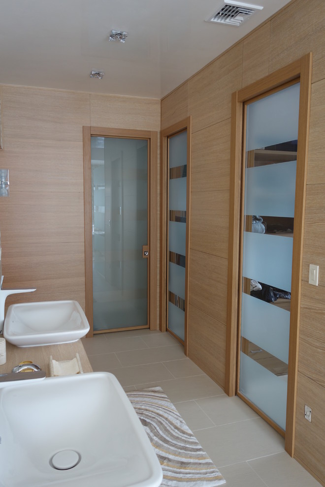 Photo of a large modern ensuite bathroom in New York with a vessel sink, flat-panel cabinets, light wood cabinets and wooden worktops.