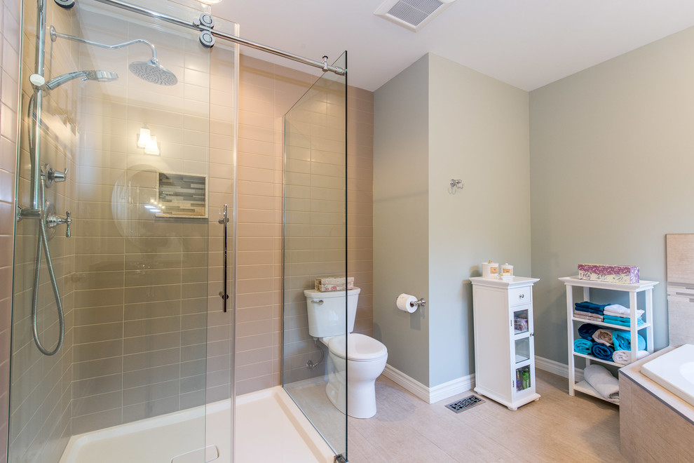 Mid-sized minimalist master beige tile and porcelain tile porcelain tile bathroom photo in San Diego with recessed-panel cabinets, medium tone wood cabinets, a two-piece toilet, beige walls, an undermount sink and laminate countertops