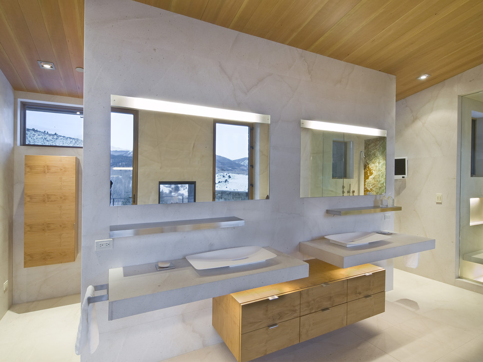 Design ideas for a modern bathroom in Denver with a vessel sink, flat-panel cabinets, concrete worktops and light wood cabinets.