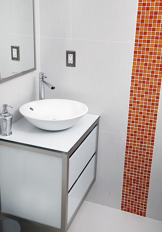 Example of a small minimalist orange tile and glass tile bathroom design in New York with white cabinets, gray walls, glass-front cabinets, a vessel sink and glass countertops