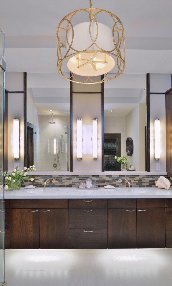 Inspiration for a traditional bathroom in Houston with a submerged sink, flat-panel cabinets, dark wood cabinets, solid surface worktops, a freestanding bath, a built-in shower, a two-piece toilet, grey tiles, porcelain tiles, grey walls and porcelain flooring.