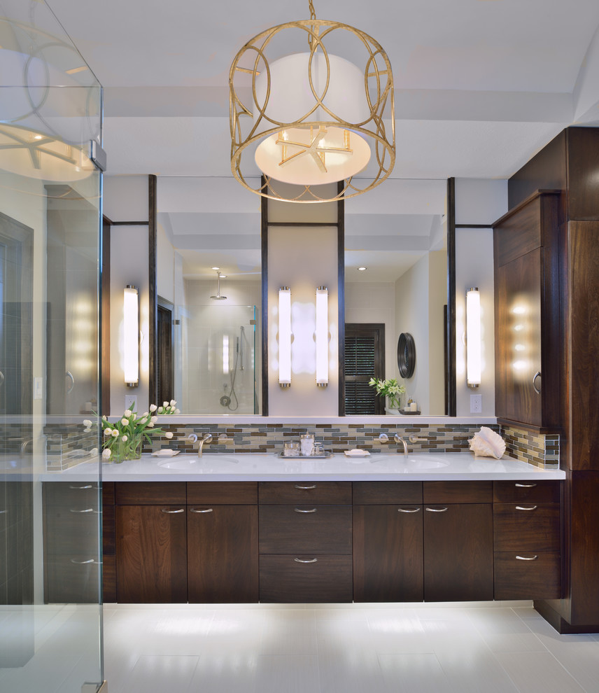 This is an example of a classic bathroom in Houston with a submerged sink, flat-panel cabinets, dark wood cabinets, solid surface worktops, a freestanding bath, a built-in shower, a two-piece toilet, grey tiles, porcelain tiles, grey walls and porcelain flooring.