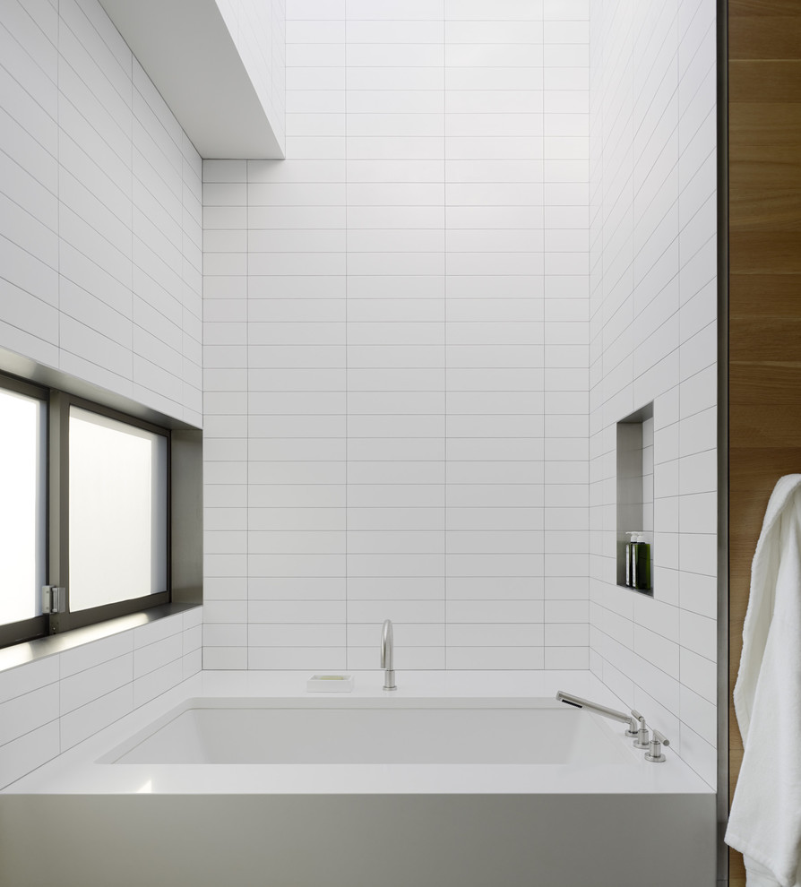 Inspiration for a modern white tile bathroom remodel in San Francisco with an undermount tub