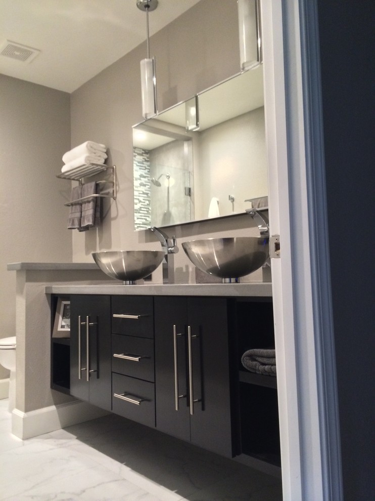 Medium sized modern shower room bathroom in San Diego with a vessel sink, black cabinets, engineered stone worktops, white tiles, porcelain tiles, grey walls, porcelain flooring, flat-panel cabinets, an alcove shower and a two-piece toilet.