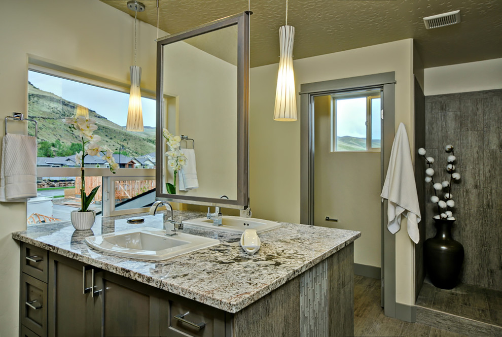 Example of a mid-sized minimalist master gray tile and porcelain tile porcelain tile double shower design in Boise with a drop-in sink, recessed-panel cabinets, gray cabinets, granite countertops, a one-piece toilet and gray walls
