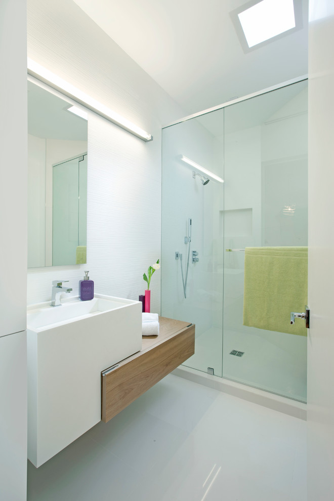 Ejemplo de cuarto de baño minimalista con armarios con paneles lisos, puertas de armario de madera oscura, ducha empotrada y baldosas y/o azulejos blancos