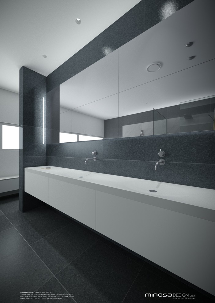 This is an example of a large modern ensuite bathroom in Sydney with flat-panel cabinets, white cabinets, solid surface worktops, a freestanding bath, a walk-in shower, grey tiles, stone slabs, white walls and slate flooring.