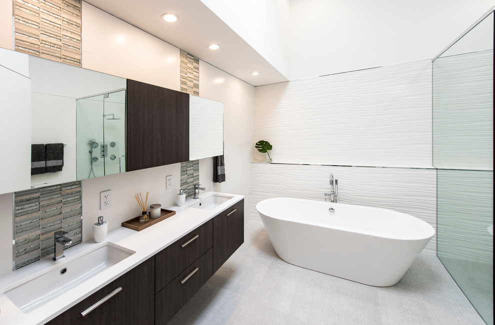 This is an example of a small modern ensuite bathroom in Miami with flat-panel cabinets, medium wood cabinets, a freestanding bath, a corner shower, a one-piece toilet, white tiles, porcelain tiles, porcelain flooring and a submerged sink.