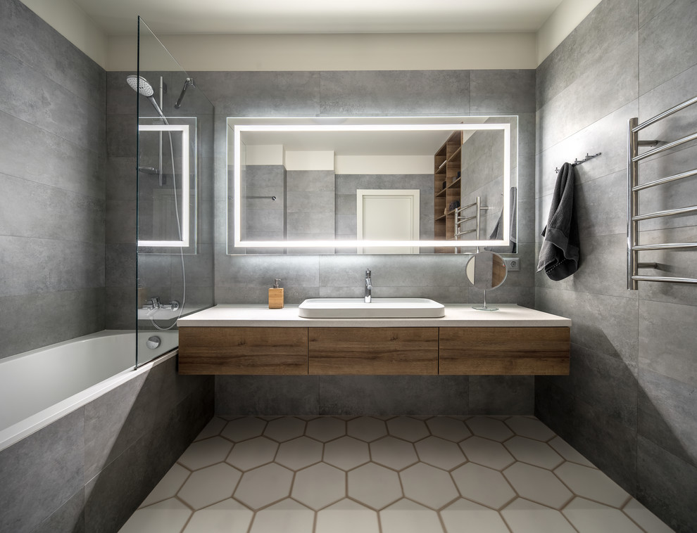 Mid-sized trendy 3/4 gray tile white floor bathroom photo in San Francisco with flat-panel cabinets, medium tone wood cabinets, white walls, a vessel sink and white countertops