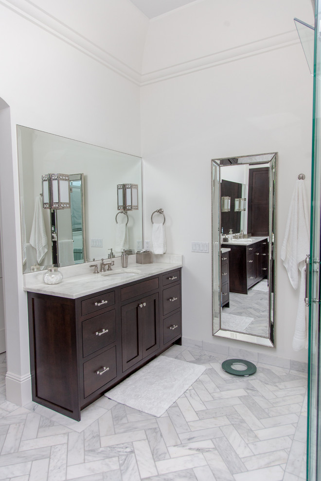 Inspiration for a large contemporary ensuite bathroom in Phoenix with flat-panel cabinets, a two-piece toilet, grey tiles, white walls, a submerged sink, marble worktops, a freestanding bath, a corner shower, dark wood cabinets, porcelain tiles and porcelain flooring.