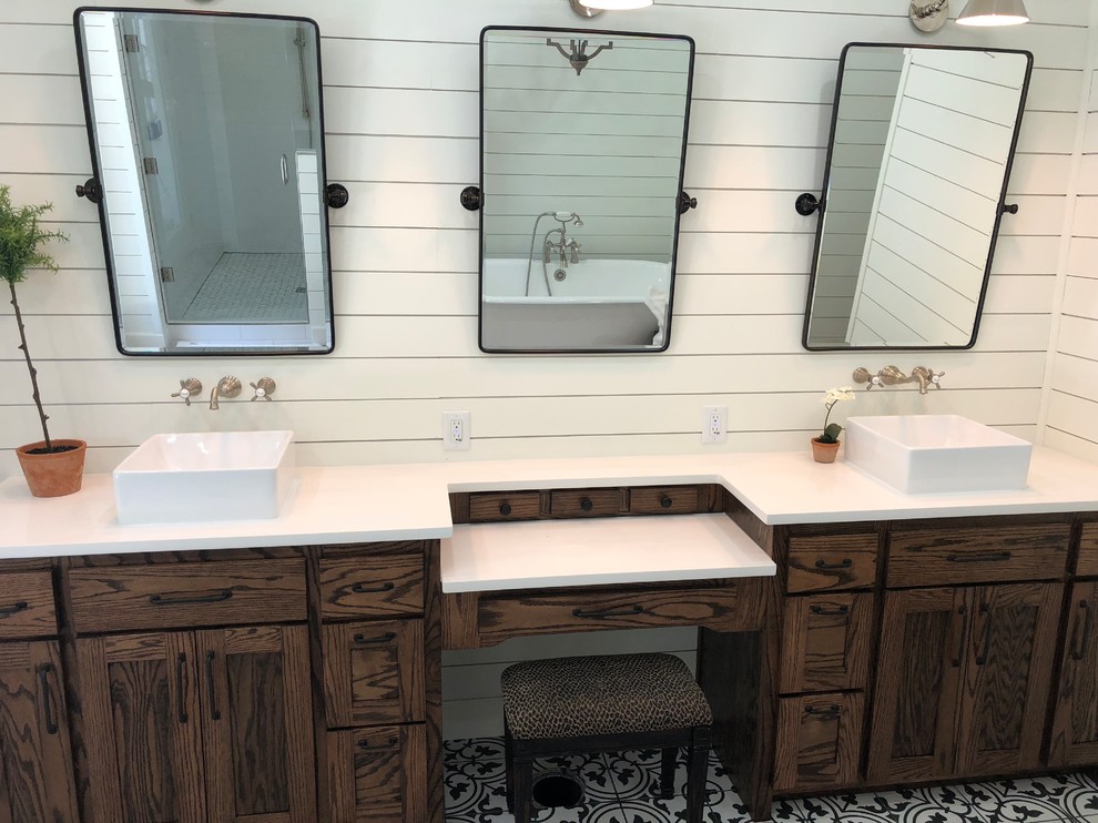 Inspiration for a large country ensuite bathroom in Other with shaker cabinets, dark wood cabinets, a freestanding bath, an alcove shower, white walls, porcelain flooring, a vessel sink, engineered stone worktops, multi-coloured floors, a hinged door and white worktops.