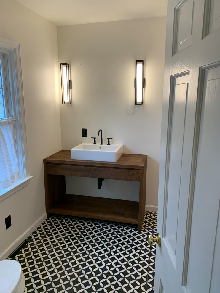 Alcove shower - mid-sized modern master white tile and subway tile ceramic tile and black floor alcove shower idea in Other with open cabinets, medium tone wood cabinets, a two-piece toilet, white walls, a console sink, wood countertops, a hinged shower door and brown countertops