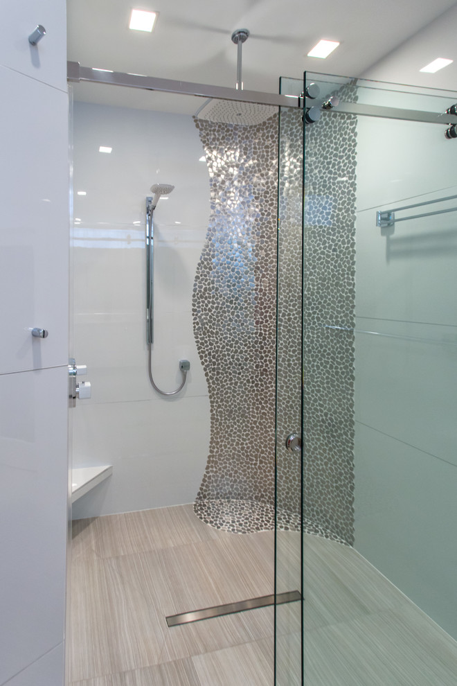 Medium sized modern ensuite bathroom in Houston with a submerged sink, flat-panel cabinets, white cabinets, engineered stone worktops, a corner shower, a one-piece toilet, white tiles, pebble tiles, white walls and porcelain flooring.