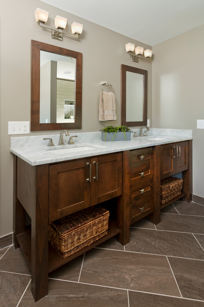 Inspiration for a large timeless master brown tile and subway tile ceramic tile bathroom remodel in Minneapolis with an undermount sink, shaker cabinets, dark wood cabinets, marble countertops, a two-piece toilet and beige walls