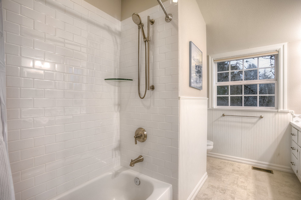 Large elegant multicolored tile and subway tile porcelain tile bathroom photo in Seattle with recessed-panel cabinets, white cabinets, a one-piece toilet, gray walls, an undermount sink and granite countertops