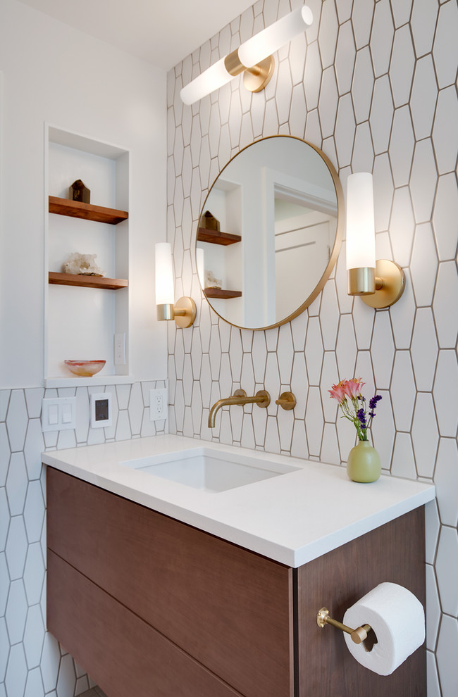 This is an example of a medium sized modern bathroom in Seattle with flat-panel cabinets, medium wood cabinets, a built-in bath, a shower/bath combination, a one-piece toilet, white tiles, cement tiles, white walls, ceramic flooring, a built-in sink, quartz worktops, a shower curtain and white worktops.