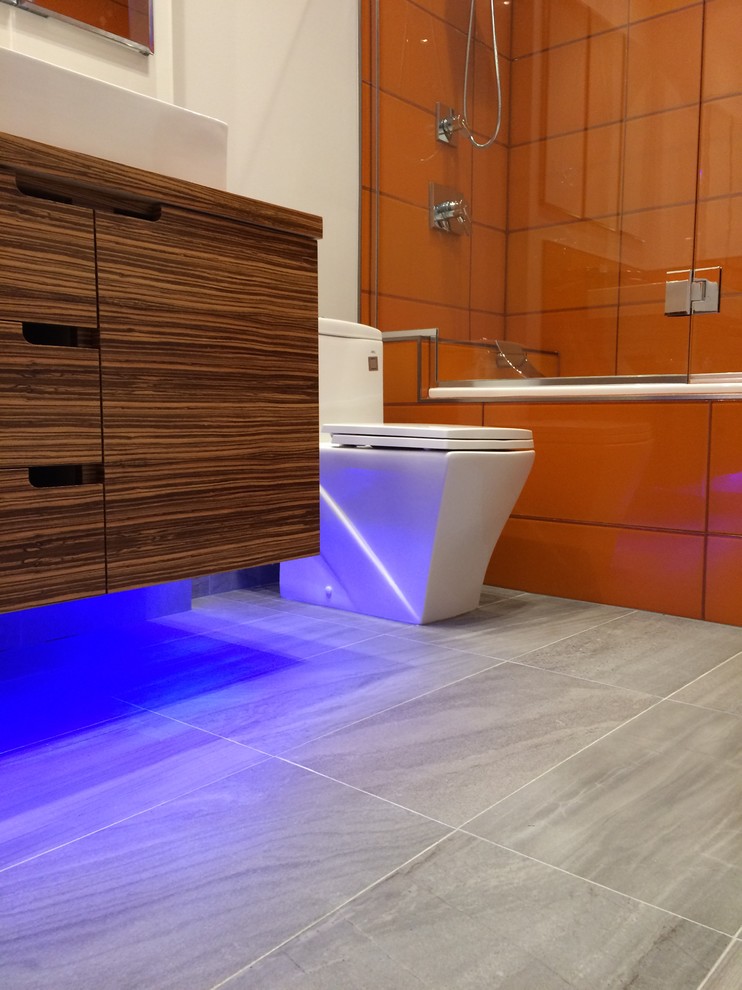 Example of a minimalist orange tile and porcelain tile ceramic tile bathroom design in Atlanta with flat-panel cabinets, medium tone wood cabinets, white walls and a vessel sink