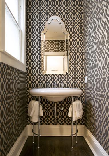 Example of a small trendy dark wood floor powder room design in San Francisco with gray walls and a console sink