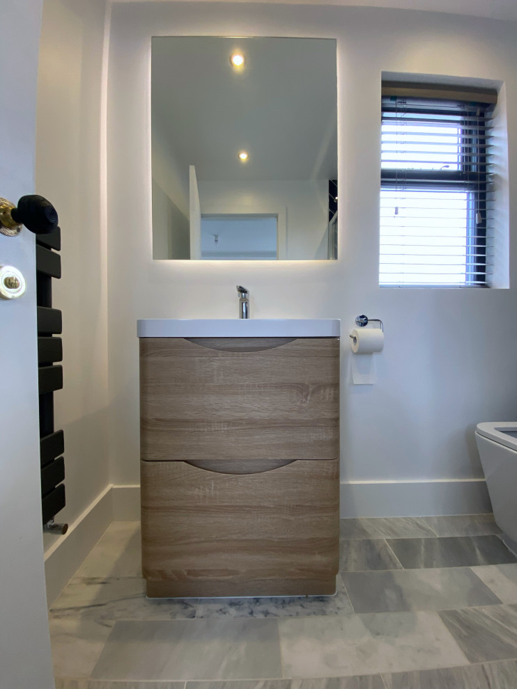 Inspiration for a small modern bathroom in London with flat-panel cabinets, brown cabinets, a freestanding bath, a walk-in shower, ceramic tiles, white walls, ceramic flooring, a built-in sink, wooden worktops, a hinged door, a two-piece toilet, green tiles, multi-coloured floors, a feature wall, a single sink and a freestanding vanity unit.