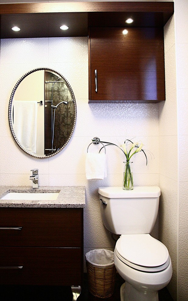 Photo of a small modern bathroom in Other with a submerged sink, flat-panel cabinets, dark wood cabinets, engineered stone worktops, a two-piece toilet, white tiles and porcelain tiles.