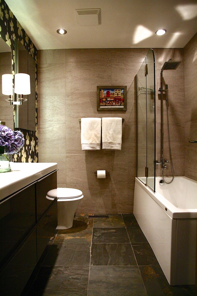 Example of a small minimalist porcelain tile tub/shower combo design in Other with an undermount sink, flat-panel cabinets, dark wood cabinets, quartz countertops and a two-piece toilet