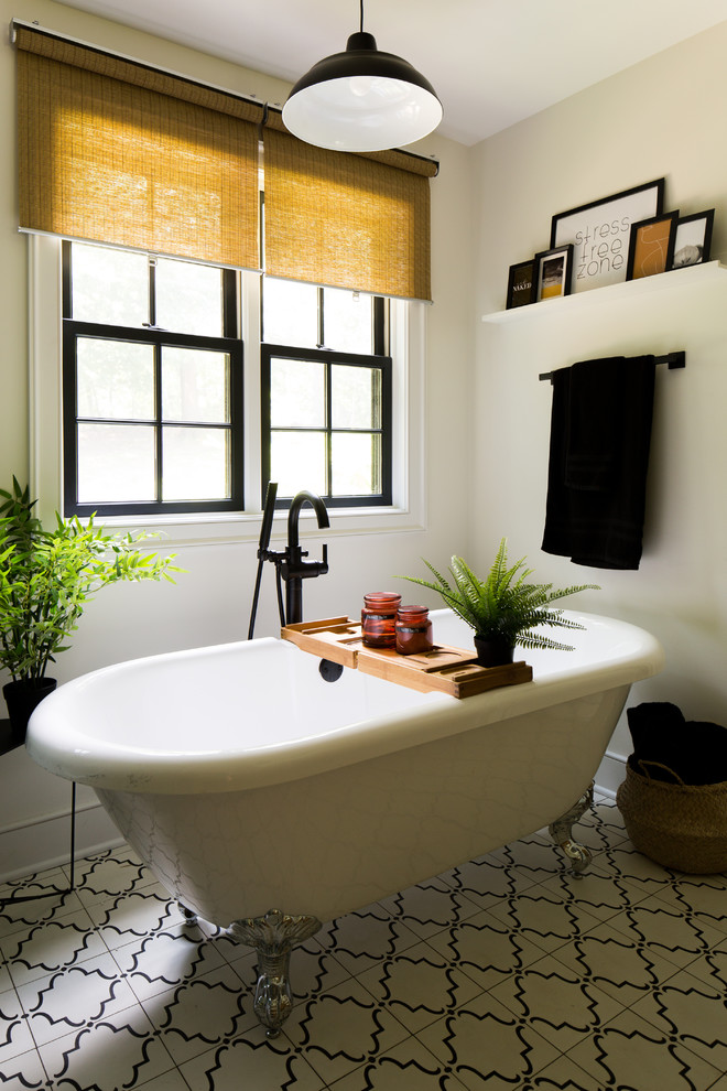 Inspiration for a large traditional ensuite bathroom in Raleigh with shaker cabinets, medium wood cabinets, a claw-foot bath, a walk-in shower, a two-piece toilet, white tiles, white walls, cement flooring, a submerged sink, limestone worktops, white floors, a hinged door and white worktops.