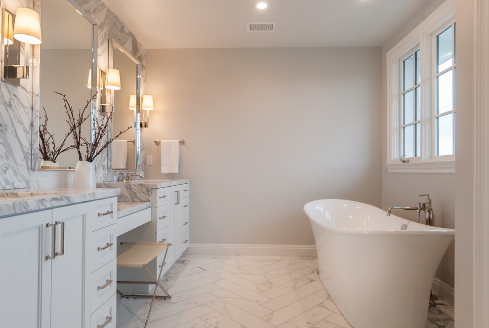 Inspiration for a classic ensuite bathroom in San Diego with shaker cabinets, white cabinets, a freestanding bath, grey tiles, marble tiles, grey walls, marble flooring, a submerged sink and marble worktops.