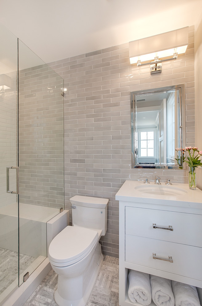 Example of a transitional gray tile and ceramic tile marble floor bathroom design in San Diego with shaker cabinets, white cabinets, gray walls, an undermount sink and quartz countertops