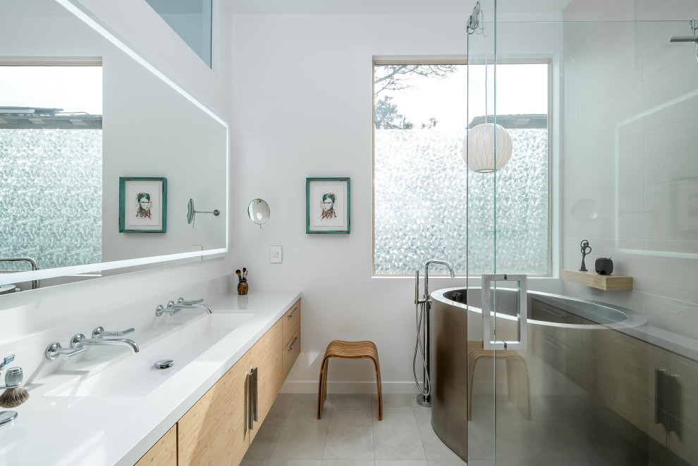 Inspiration for a mid-sized contemporary master porcelain tile and beige floor bathroom remodel in San Diego with flat-panel cabinets, light wood cabinets, white walls, an undermount sink, solid surface countertops, a hinged shower door and white countertops