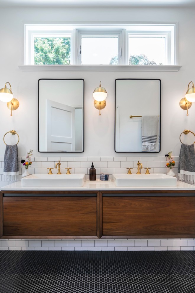 Bathroom - mid-sized transitional master white tile and ceramic tile mosaic tile floor and black floor bathroom idea in Los Angeles with flat-panel cabinets, dark wood cabinets, a two-piece toilet, white walls, a vessel sink, quartz countertops, a hinged shower door and white countertops