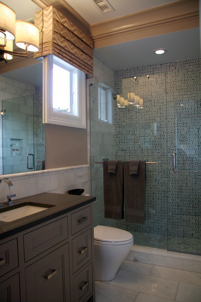 Mid-sized transitional 3/4 multicolored tile and mosaic tile marble floor alcove shower photo in New York with recessed-panel cabinets, gray cabinets, a one-piece toilet, beige walls, an undermount sink and quartz countertops