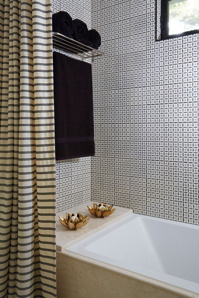 This is an example of a small traditional ensuite bathroom in Los Angeles with recessed-panel cabinets, black cabinets, a built-in bath, a shower/bath combination, a one-piece toilet, beige tiles, porcelain tiles, beige walls, ceramic flooring, a submerged sink, limestone worktops, beige floors and a shower curtain.