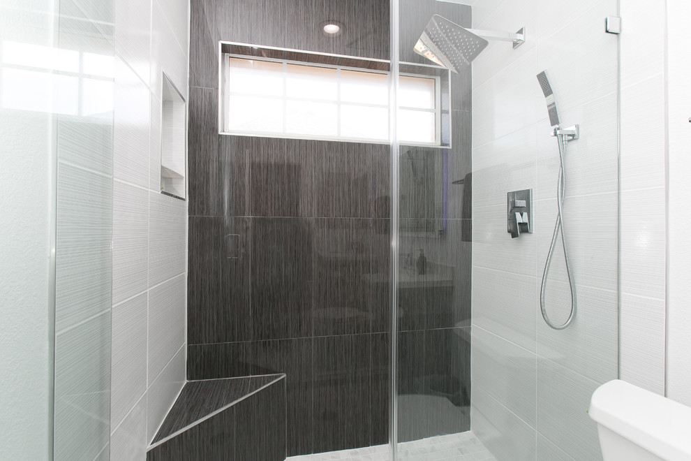 Inspiration for a small modern shower room bathroom in Dallas with beaded cabinets, grey cabinets, an alcove shower, a two-piece toilet, black tiles, porcelain tiles, white walls, porcelain flooring, a submerged sink, engineered stone worktops, white floors, a hinged door and white worktops.