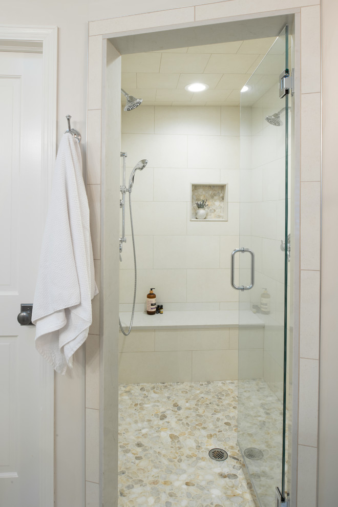 This is an example of a medium sized classic ensuite wet room bathroom in Minneapolis with a freestanding bath, beige tiles, porcelain flooring, a submerged sink, engineered stone worktops, beige floors, a hinged door and white worktops.