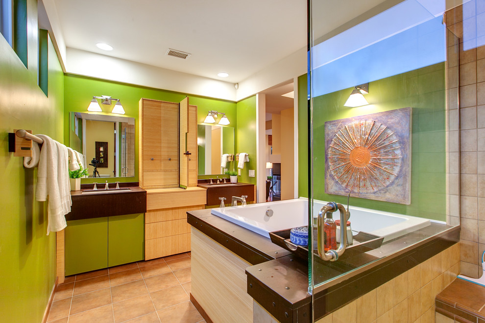 Large contemporary ensuite bathroom in San Diego with a submerged sink, flat-panel cabinets, light wood cabinets, a japanese bath, green walls and porcelain flooring.