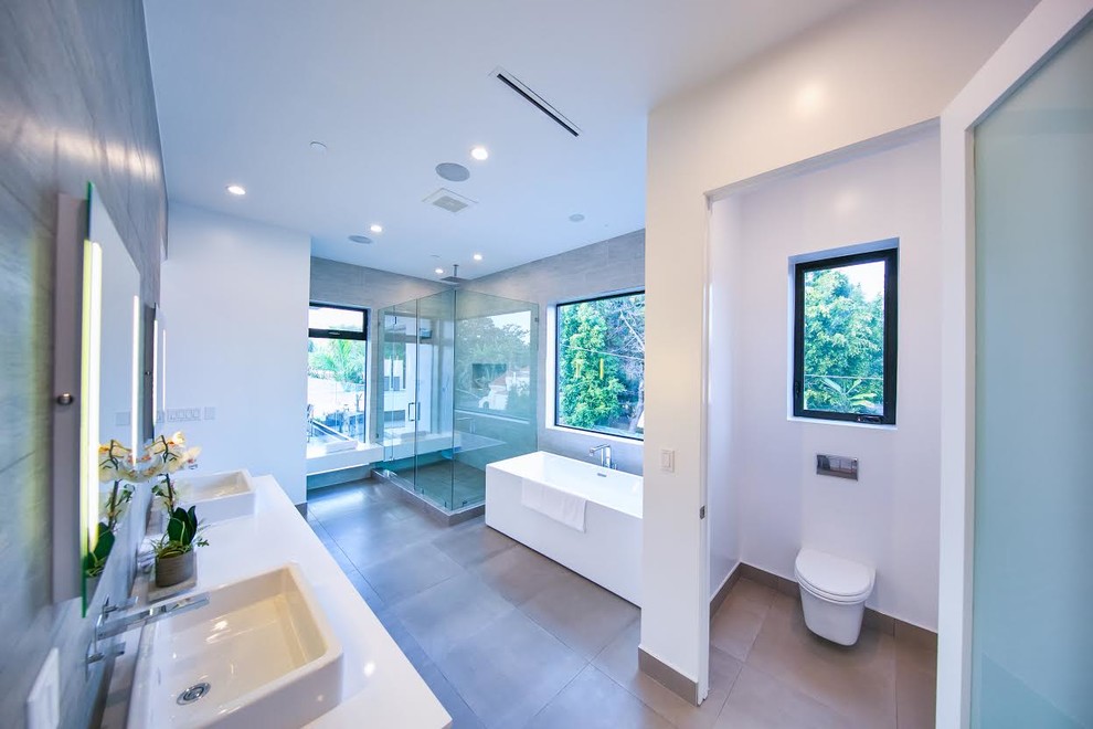 Пример оригинального дизайна: большая главная ванная комната в современном стиле с накладной ванной, душем без бортиков, биде, белыми стенами, накладной раковиной, столешницей из гранита и душем с распашными дверями