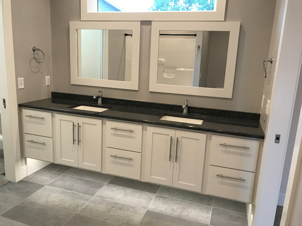 Photo of a medium sized modern ensuite bathroom in Other with shaker cabinets, white cabinets, ceramic flooring, a submerged sink, granite worktops and grey floors.