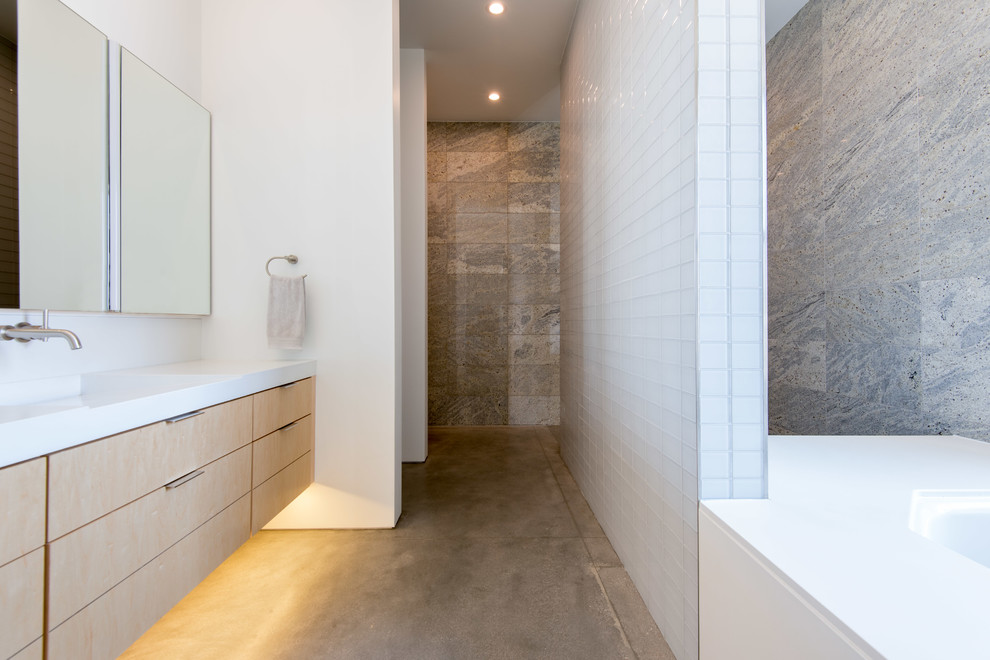 Photo of a medium sized contemporary ensuite bathroom in Las Vegas with flat-panel cabinets, beige cabinets, a corner bath, a walk-in shower, white tiles, glass tiles, concrete flooring, an integrated sink, quartz worktops, grey floors, an open shower, white worktops and white walls.