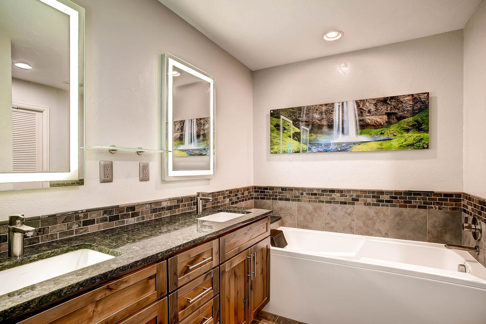 Medium sized classic ensuite bathroom in Denver with shaker cabinets, medium wood cabinets, an alcove bath, a walk-in shower, beige tiles, brown tiles, stone tiles, beige walls, slate flooring, a submerged sink and granite worktops.