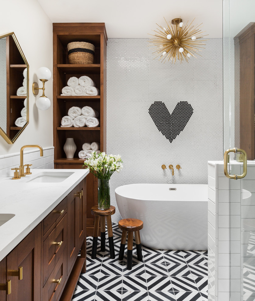 Inspiration for a transitional master black tile, black and white tile, white tile and ceramic tile multicolored floor and cement tile floor bathroom remodel in Albuquerque with an undermount sink, recessed-panel cabinets, medium tone wood cabinets, white walls, quartzite countertops, a hinged shower door and white countertops