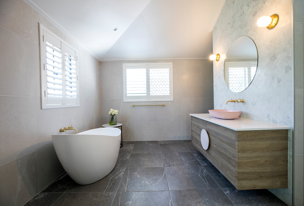 Design ideas for a large eclectic ensuite bathroom in Townsville with flat-panel cabinets, blue cabinets, a freestanding bath, a built-in shower, grey tiles, ceramic tiles, ceramic flooring, engineered stone worktops, grey floors, a hinged door and white worktops.